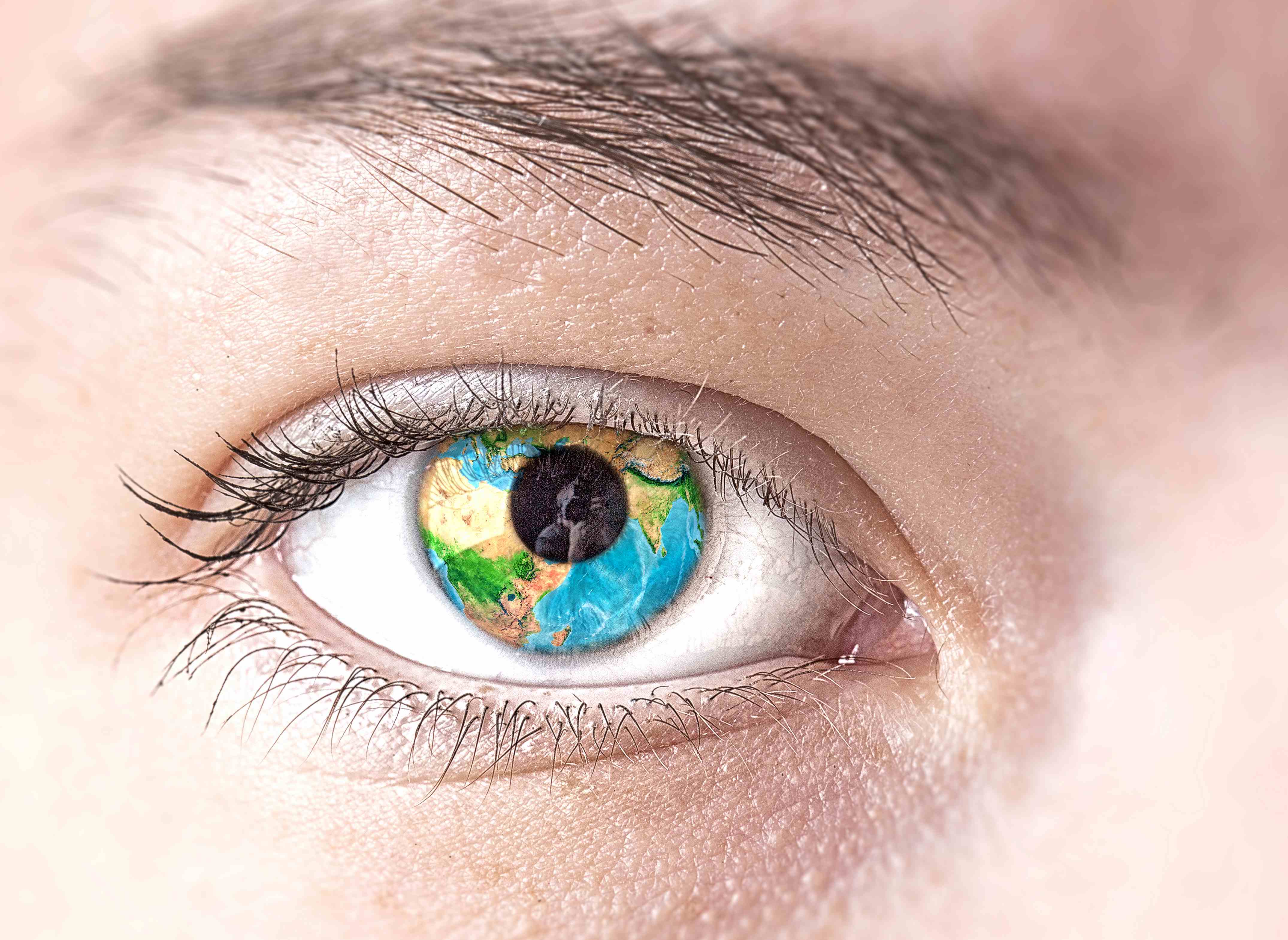 Close-up of an eye with the Earth reflected in the iris. Credits: Mostphotos.