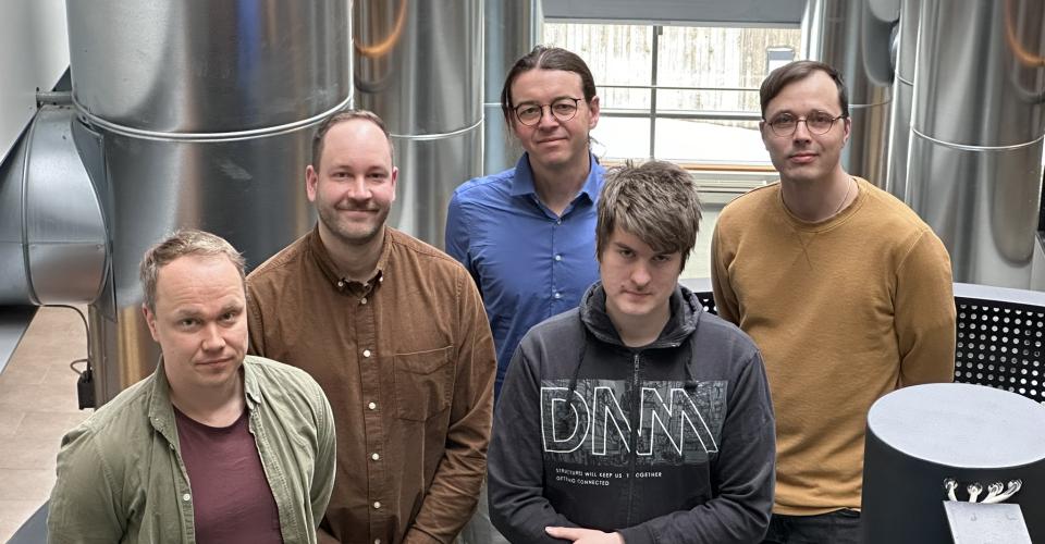 A group photo of the five local analysts standing.