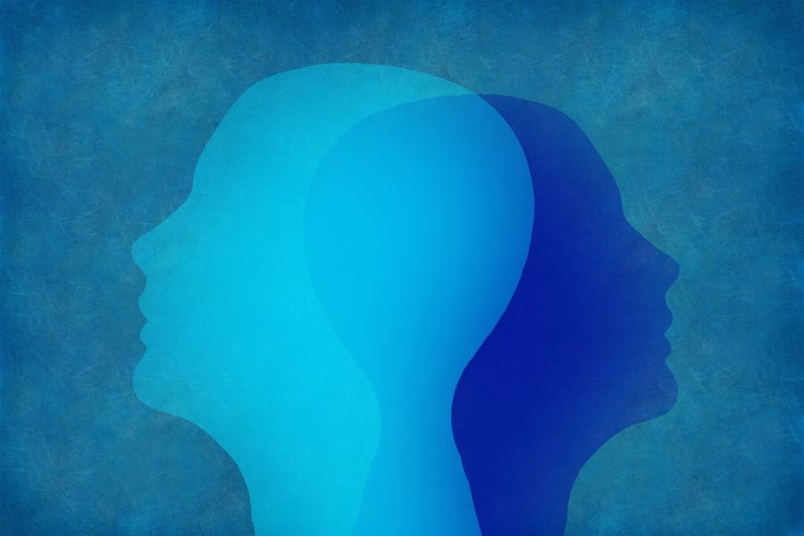 A blue-toned abstract image showing two superimposed human profiles.