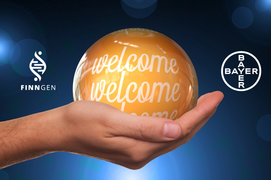 Käsi joka pitelee hohtavaa oranssia palloa, jossa on teksti "Welcome", sekä FinnGenin ja Bayerin logot.